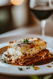 Piece of lasagna on white plate. KI generiert, generiert, AI generated