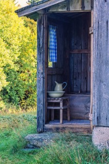 Idyllic old outhouse with a jug and sink in the country at summer, Sweden, Europe