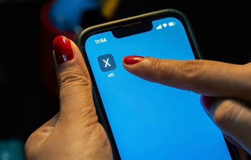 In this photo illustration, A person browses website of xAI, displayed on a mobile phone, Elon Musk