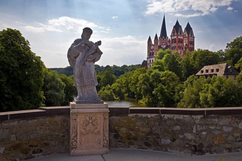 Statue of the bridge saint Nepomuk on the Old Lahn Bridge with Limburg Cathedral St. George,