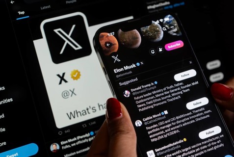 In this photo illustration a person browsing Elon musk X account, formerly Twitter, on an iPhone,