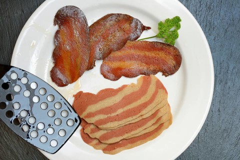 Artificial bacon as imitation meat, imitation bacon on plate, meat substitute