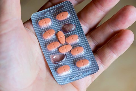 Hand holding a blister pack with tablets