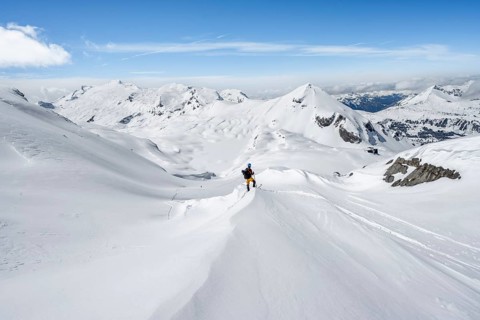 Ski tourers ascending to the Wildstrubel hut, snow-covered mountain landscape with Mittaghorn and