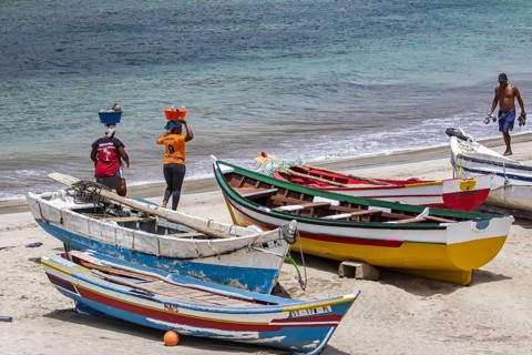 Two local Cape Verdean women transporting food on their heads on the beach near Tarrafa on the