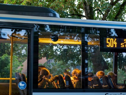 School bus and regional bus at a stop, children sitting in it, Schlepzig, Brandenburg, Germany,