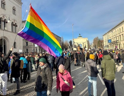 LGBTQ flag, crowd at the demonstration against right-wing extremism in front of the Siegestor in