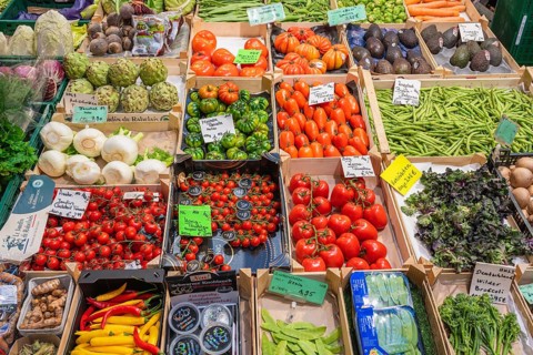Market stall with a wide range of local and exotic vegetables in the Markthalle Stuttgart,