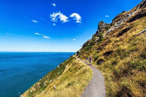 Walkers on South West Coast Path, coastal path, Valley of the Rocks, rocky coast in Exmoor National