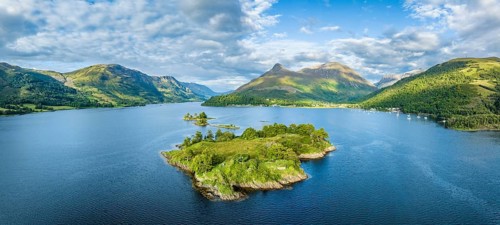 Aerial panorama of the western part of Loch Leven with the historic island of Eilean Munde, above