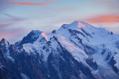 Red-coloured clouds over the summit of Mont Blanc with Aiguille du Midi in the foreground, Savoie,