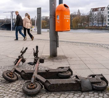 Rusty electric scooters on public streets, East Side Galery in Berlin-Mitte, Berlin, Germany,