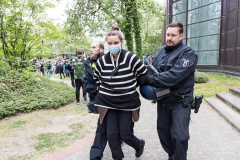 An activist is taken away by the police during the occupation of the courtyard of the Free