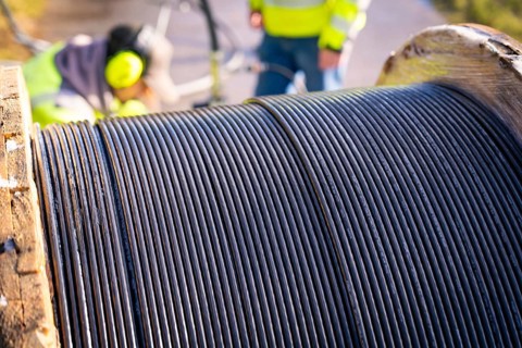 Detailed view of the cable spool on a machine reel with focus on the cables, fibre optic