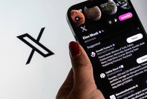 In this photo illustration a person browsing Elon musk X account, formerly Twitter, on an iPhone,