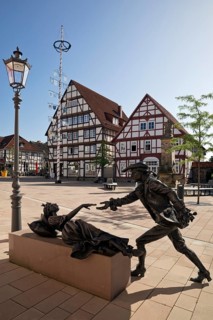 Sleeping Beauty sculpture by Karin Bohrmann-Roth in the old town, fairy tale based on the Brothers