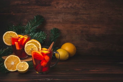 Two glass cups with punch, Christmassy, wooden background, copy room
