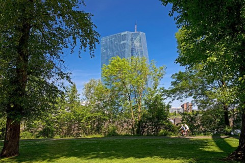 The European Central Bank ECB stands out behind a green park on Deutschherrnufer, Frankfurt am