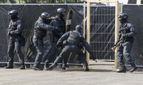 Police officers from the Berlin Special Operations Command, SEK, simulate an attack during an