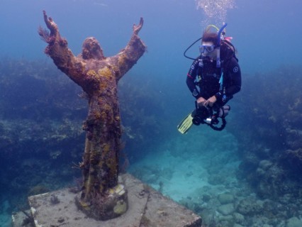 Diver looking at the statue of Jesus Christ underwater (Christ of the Abyss), dive site John
