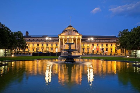 Illuminated spa hotel and Casino in the evening with cascade fountain, Wiesbaden, Hesse, Germany,