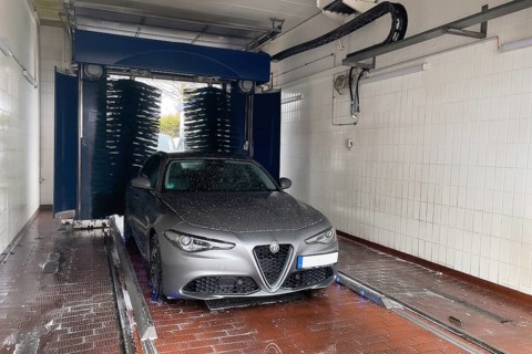 Front view of motor vehicle sporty sedan Italian make automobile Alfa Romeo Giulia being sprayed in