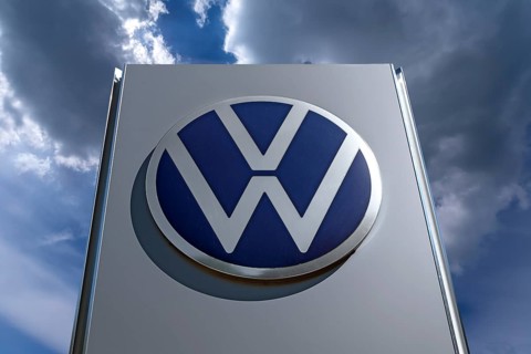 Logo of the car company Volkswagen, cloudy sky, Bavaria, Germany, Europe