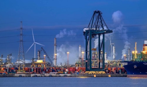 Container terminal showing wharf with stacked containers, gantry crane, portainer crane along the