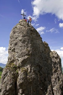 Man climbs to the summit cross on the Losenstein, Austria, Europe
