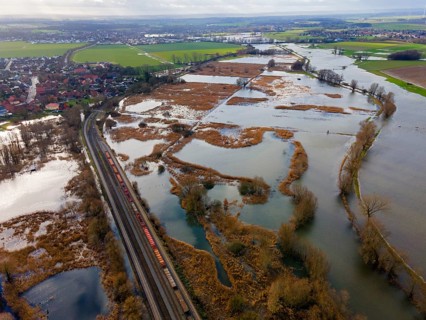 Aerial view of a flooded landscape with railway traffic and winding waterways, flood, Christmas,