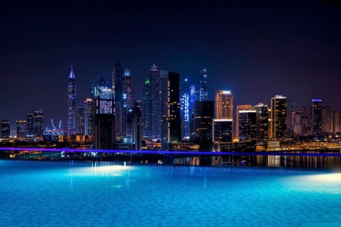 Night shot rooftop pool, swimming pool, Dubai Marina skyline behind, Hotel NH Collection The Palm