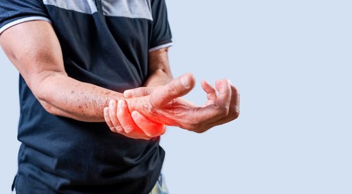 Elderly person with arthritis in hands on isolated background. Hands of elderly people with