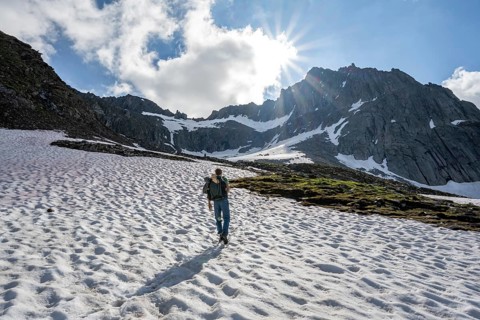 Mountaineer on a snowfield, rocky mountain peak Furtschaglspitze in the background, Berliner