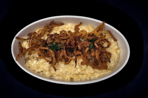 Cheese spaetzle with fried onions on a dark background, Bavaria, Germany, Europe