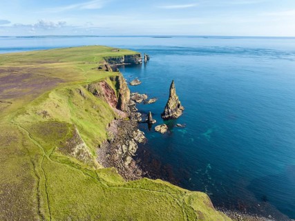Aerial view of the rugged coastal landscape with the Duncansby Stacks, Duncansby Head coast, County