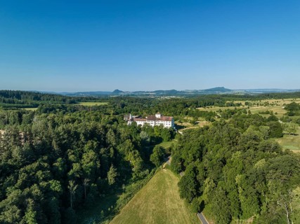 Aerial view of Langenstein Castle near Eigeltingen with surrounding golf course, on the horizon the