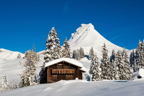 Snow-covered mountains and mountain hut with ski slope, Damülser Mittagspitze, Damüls,