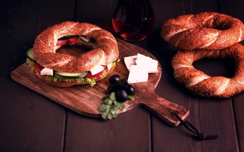 Traditional Turkish bagel simit, breakfast, on a wooden table, rustic, horizontal, no people