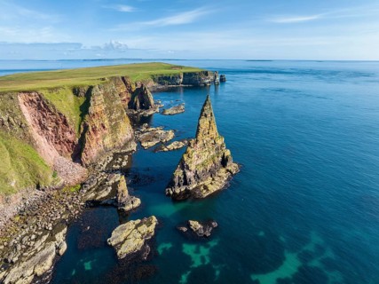 Aerial view of the rugged coastal landscape with the Duncansby Stacks, Duncansby Head coast, County