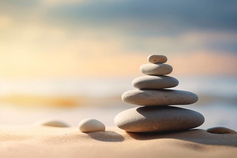Zen stones stack on sand waves in a minimalist setting for balance and harmony. Balance, harmony,
