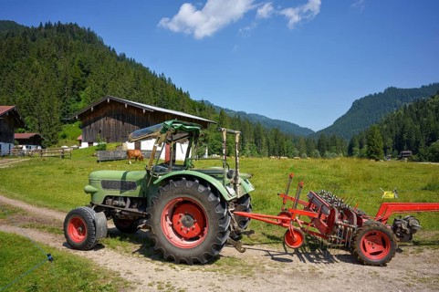 Old Fendt Famer 2 tractor with Pöttinger hay caterpillar at Rötelmoosalm in Bavaria, Germany,