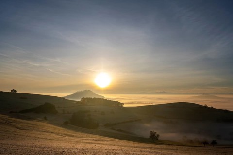 View from the old post road near Leipferdingen into the wintry and misty Hegaulandschaft at
