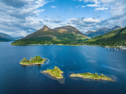 Aerial view of the western part of the freshwater loch Loch Leven with a group of islands, far left