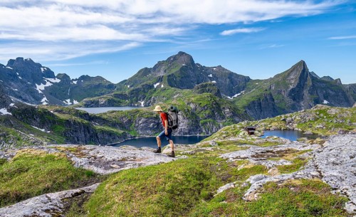Mountaineer, mountain landscape with rocky pointed peaks and lakes, with mountain
