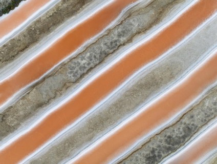 Saline ponds at the salt works near Chiclana de la Frontera. The orange-red colour depends on the