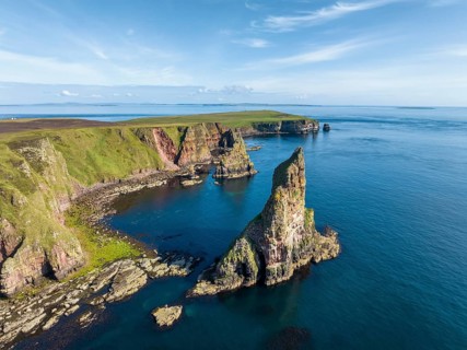 Aerial view of the rugged coastal landscape with the Duncansby Stacks, Duncansby Head coast, County