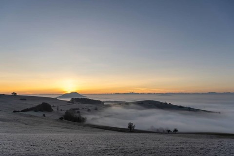 View from the old post road near Leipferdingen into the wintry and misty Hegaulandschaft shortly in