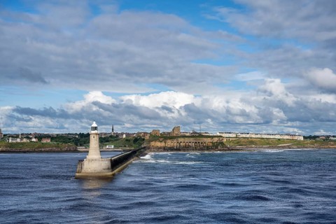 Tynemouth Lighthouse with the ruins of Tynemouth Priory and Castle behind, North Shields, Newcastle