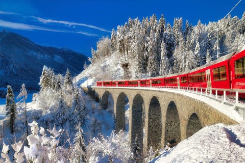 Rhaetian railway on viaduct in winter landscape, near Filisur, Canton Graubünden, Switzerland,