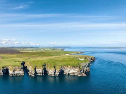 Aerial view of the rugged coastal landscape at Duncansby Head with the lighthouse, Scotland's